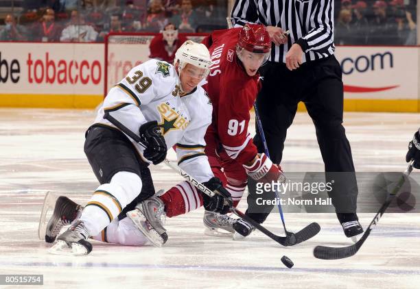 Center Kyle Turris of the Phoenix Coyotes fights for a loose puck with Joel Lundqvist of the Dallas Stars on April 3, 2008 at Jobing.com Arena in...