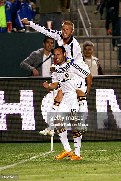 Landon Donovan of the Los Angeles Galaxy celebrates with teammate David Beckham after scoring a goal during the MLS soccer match against the San Jose...
