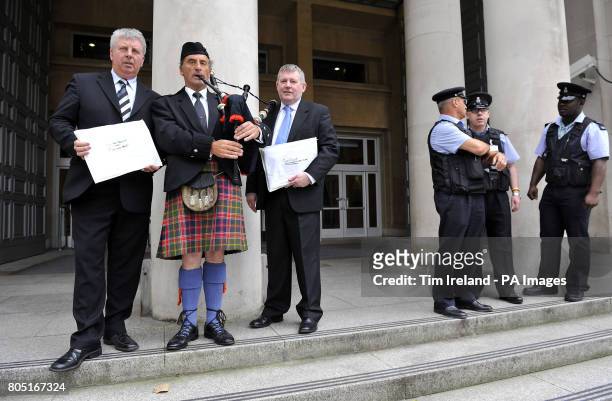 Angus MacMillan, Chairman of Storas Uibhist, piper James MacKay and Angus Campbell, Chairman of the Hebrides Range Taskforce outside the Ministry of...