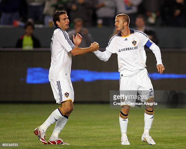 David Beckham celebrates scoring a goal with Alan Gordon against the San Jose Earthquakes during the game at Home Depot Center on April 3, 2008 in...