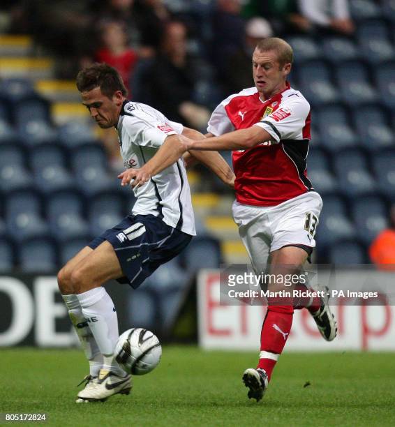 Preston's Darren Carter battles with Morecambe's Ian Craney during the Carling Cup First Round match at Deepdale, Preston.