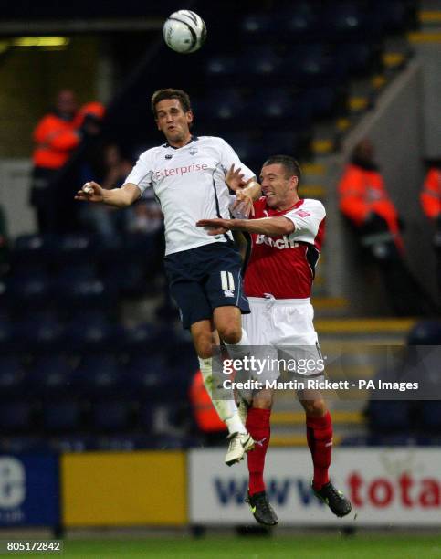 Preston's Darren Carter and Morecambe's Ian Craney battle for a ball in the air during the Carling Cup First Round match at Deepdale, Preston.
