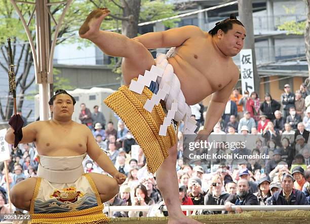 Grand champion Asashoryu performs prior to his fight during Yasukuni Shrine Dedication Sumo Tournament at Yasukuni Shrine on April 4, 2008 in Tokyo,...