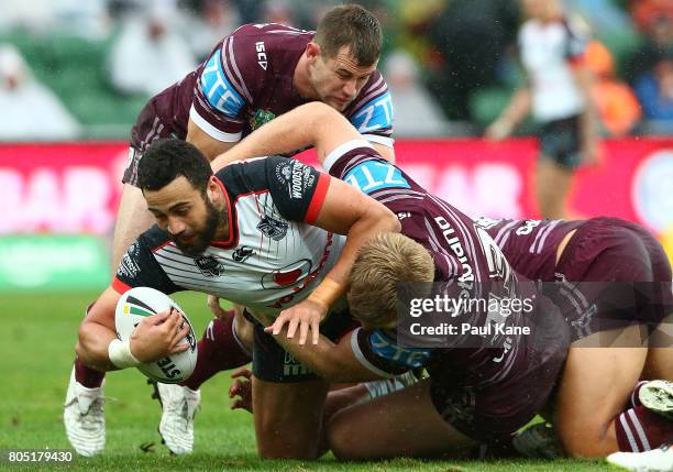 Ben Matulino of the Warriors gets tackled during the round 17 NRL match between the Manly Sea Eagles and the New Zealand Warriors at nib Stadium on...