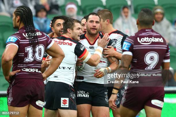 Simon Mannering of the Warriors is congratulated by team mates after crossing for a try during the round 17 NRL match between the Manly Sea Eagles...