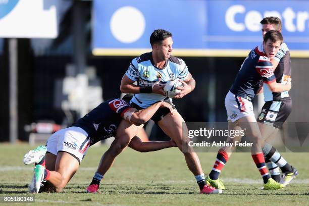 Gerard Beale of the Sharks is tackled by the Roosters defence during the round 17 NRL match between the Sydney Roosters and the Cronulla Sharks at...