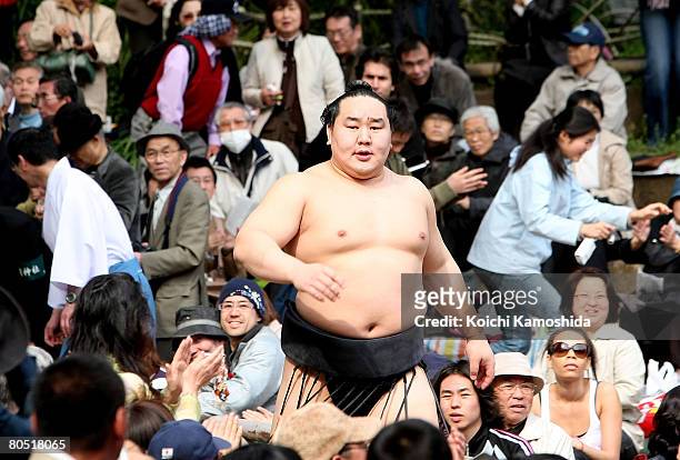 Grand champion Asashoryu of Mongolian walks between fans during Yasukuni Shrine Dedication Sumo Tournament at Yasukuni Shrine on April 4, 2008 in...