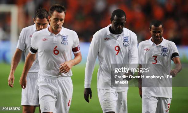 England's John Terry, Emile Heskey and Ashley Cole walk off dejected at half time during the International Friendly match at the Amsterdam ArenA,...