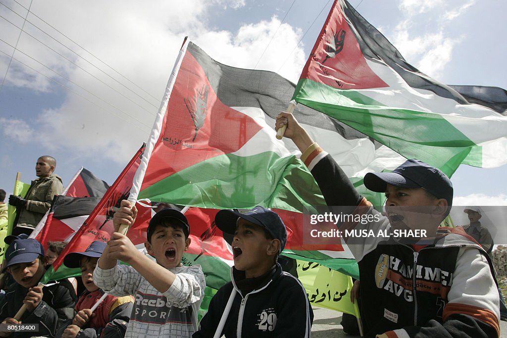 Palestinian boys wave national flags dur