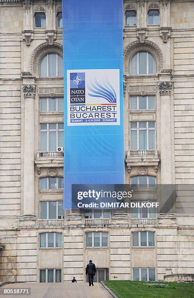 Man walks towards the Parliament Palace, the second largest building in the world after the Pentagon, in Bucharest on April 1, 2008 on the eve of the...