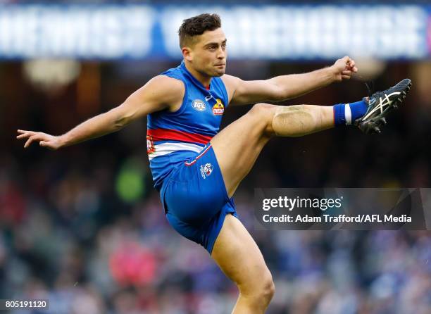 Luke Dahlhaus of the Bulldogs kicks the ball during the 2017 AFL round 15 match between the Western Bulldogs and the West Coast Eagles at Etihad...