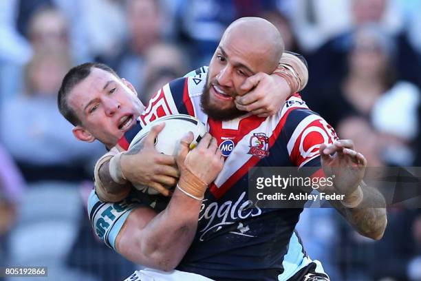 Blake Ferguson of the Roosters is tackled by Paul Gallen of the Sharks during the round 17 NRL match between the Sydney Roosters and the Cronulla...