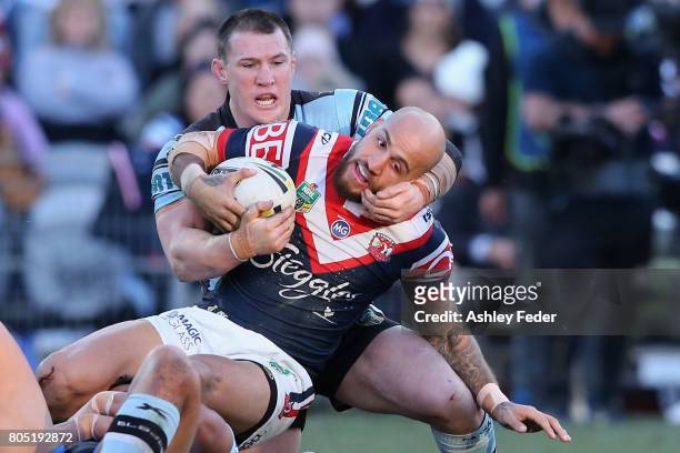 Blake Ferguson of the Roosters is tackled by Paul Gallen of the Sharks during the round 17 NRL match between the Sydney Roosters and the Cronulla...