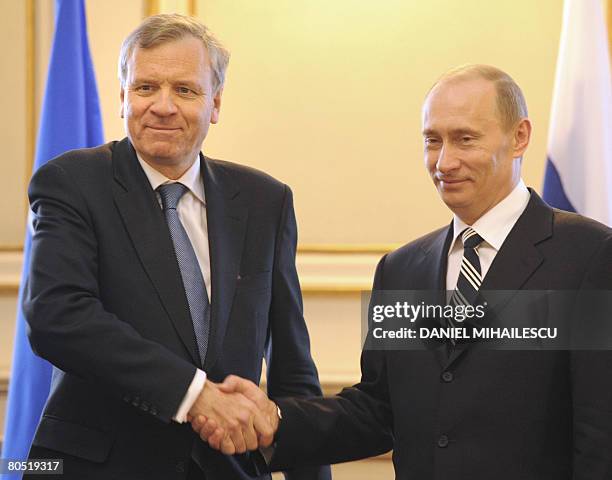 Nato Secretary General Jaap de Hoop Scheffer and Russian President Vladimir Putin shake hands after Russian Foreign Minister Sergey Lavrov and...