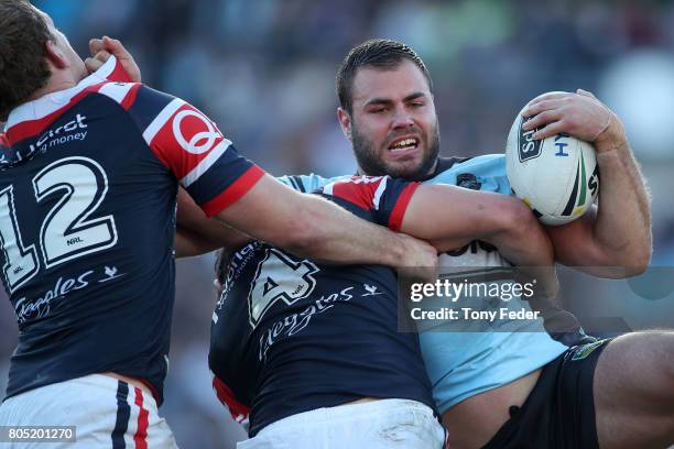 Wade Graham of the Sharks is tackled during the round 17 NRL match between the Sydney Roosters and the Cronulla Sharks at Central Coast Stadium on...