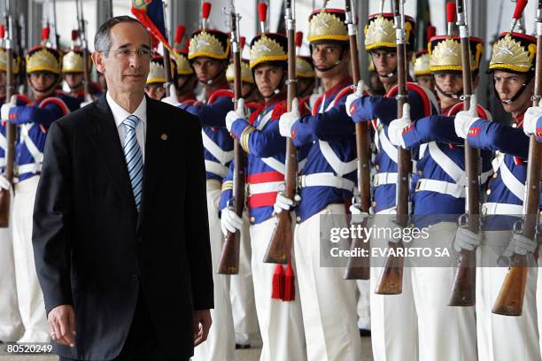 Guatemala's President Alvaro Colom reviews the honour guard during the welcoming ceremony at Planalto Palace, on April 4 in Brasilia. Colom is on a...