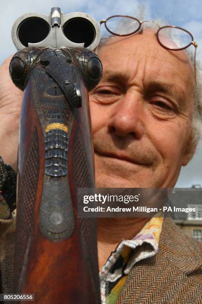 Gun Engraver Malcolm Appleby holds an unusual 12-bore "Crocodile" gun by David McKay Brown. Malcolm engraved the gun to look like a crocodile and it...