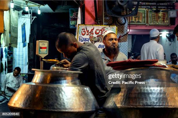 Service boy is collecting Biriyani in a food-joint opposite to Jama Masjid. Jama Masjid situated in one of the most crowded area of New Delhi,...