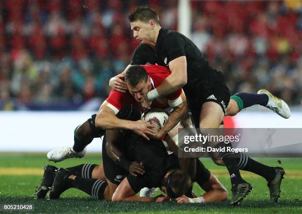 Sam Warburton of the Lions is tackled by Beauden Barrett of the All Blacks and teammates during the second test match between the New Zealand All...