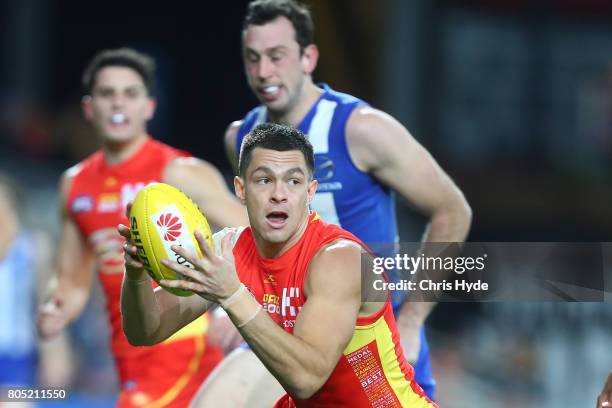Jesse Lonergan of the Suns runs the ball during the round 15 the Gold Coast Suns and the North Melbourne Kangaroos at Metricon Stadium on July 1,...