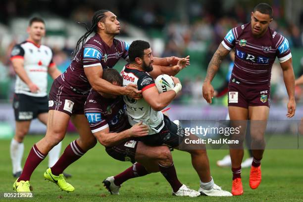 Ben Matulino of the Warriors gets tackled by Martin Taupau and Brenton Lawrence of the Sea Eagles during the round 17 NRL match between the Manly Sea...