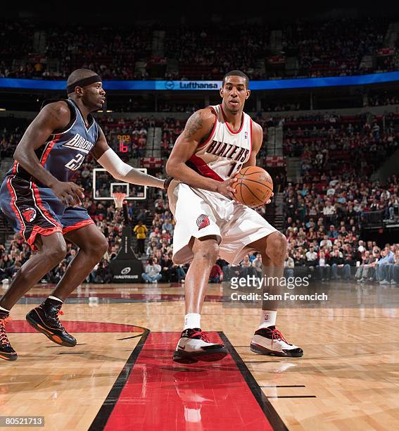 LaMarcus Aldridge of the Portland Trail Blazers holds the ball against Jason Richardson of the Charlotte Bobcats during a game at the Rose Garden...