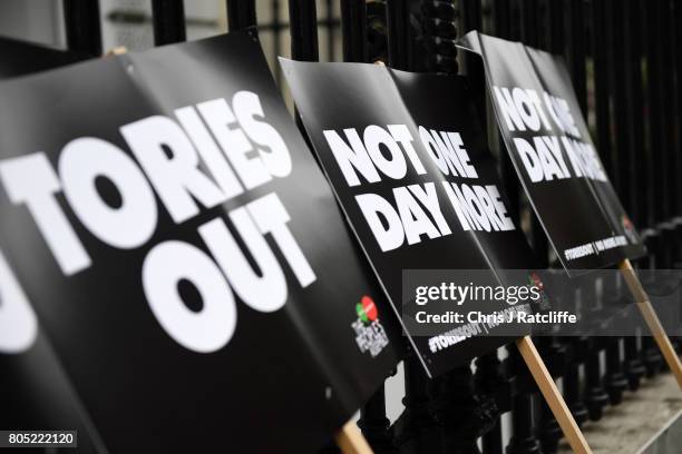 Placards are seen prior to the 'Not One Day More' march at BBC Broadcasting House on July 1, 2017 in London, England. Thousands of protesters joined...