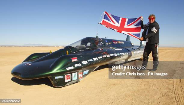 The financial backer and driver of The British Steam Car Challenge team Charles Burnett III celebrates beside his vehicle at Rogers Dry Lake on...