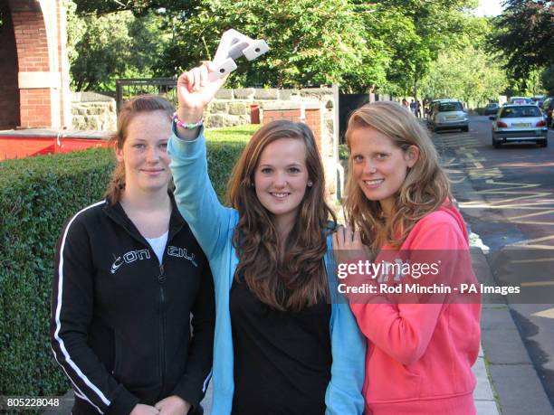 Rachael Oswald celebrates her GCSE results at Church High School, in Jesmond, Newcastle, with her older sisters Sarah and Anna.