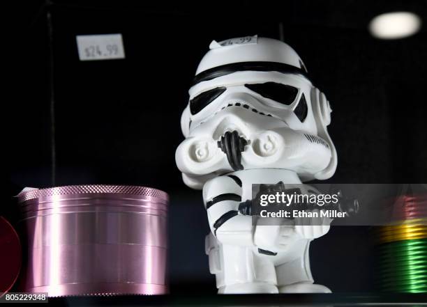 Grinders, including one shaped like a stormtrooper from the "Star Wars" movie franchise, are displayed at Essence Vegas Cannabis Dispensary before...