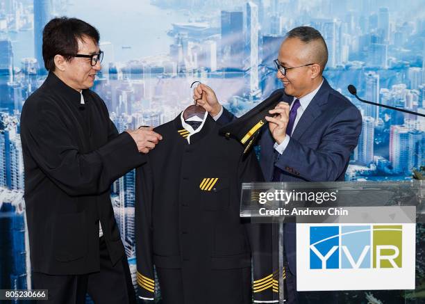 Actor and martial artist Jackie Chan receives a pilot's suit from Chief Marketing Officer of Hong Kong Airlines George Liu during the celebration of...