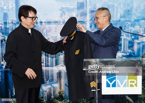 Actor and martial artist Jackie Chan receives a pilot's suit from Chief Marketing Officer of Hong Kong Airlines George Liu during the celebration of...