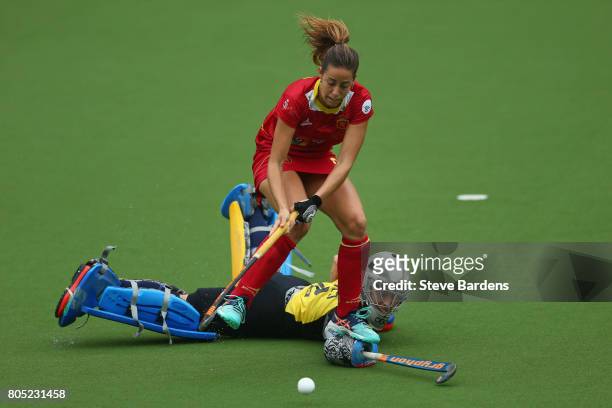 Maria Lopez of Spain goes around Martina Chico of Italy to score during the penalty shoot out during the Fintro Hockey World League 5/8 place playoff...