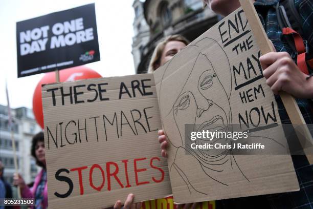 Demonstrators carry placards during the Not One Day More march at BBC Broadcasting House on July 1, 2017 in London, England. Thousands of...