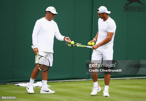 Rafael Nadal of Spain with coach Toni Nadal during a practice session ahead of the Wimbledon Lawn Tennis Championships at the All England Lawn Tennis...