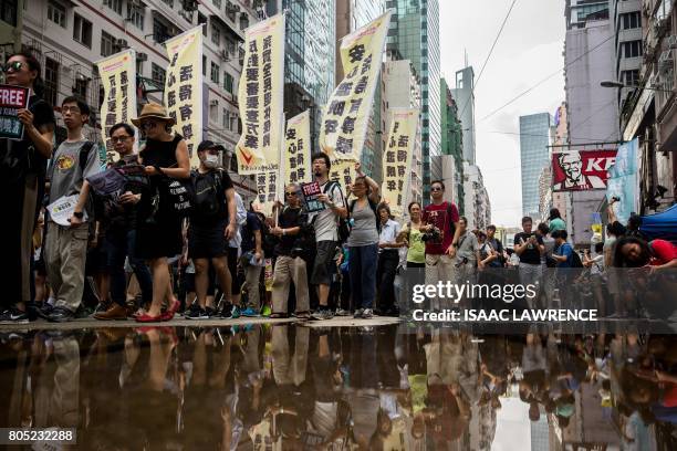 People attend a protest march in Hong Kong on July 1 coinciding with the 20th anniversary of the city's handover from British to Chinese rule....