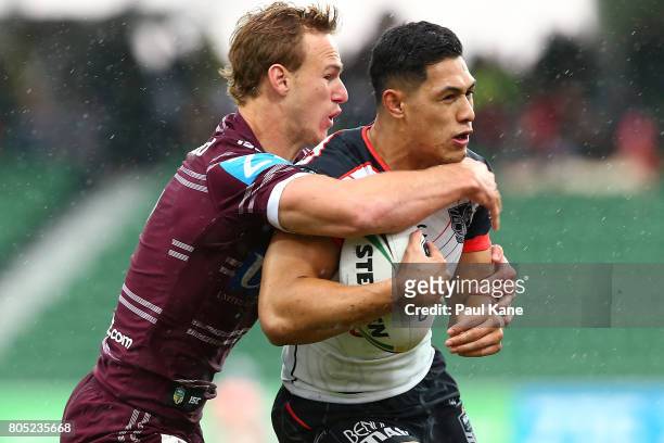 Daly Cherry-Evans of the Sea Eagles tackles Roger Tuivasa-Sheck of the Warriors during the round 17 NRL match between the Manly Sea Eagles and the...