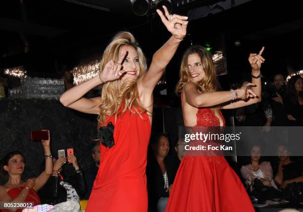 Presenters Candice De Saint Pern by Pierre Cardin and Margaux De Frouville by Laura Laval walk the runway during the 'Red Defile' Auction Fashion...