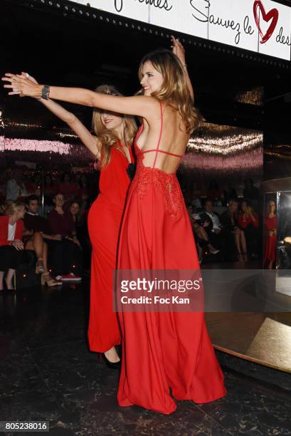 Presenters Candice De Saint Pern by Pierre Cardin and Margaux De Frouville by Laura Laval walk the runway during the 'Red Defile' Auction Fashion...