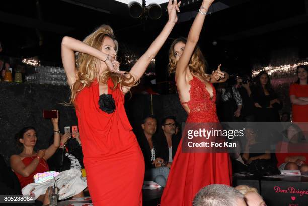 Presenters Candice De Saint Pern by Pierre Cardin and Margaux De Frouville by Laura Laval walk the runway during the 'Red Defile' Auction Fashion...