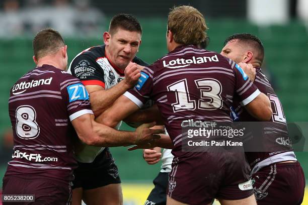 Jacob Lillyman of the Warriors gets tackled by Brenton Lawrence, Jake Trbojevic and Lewis Brown of the Sea Eagles during the round 17 NRL match...