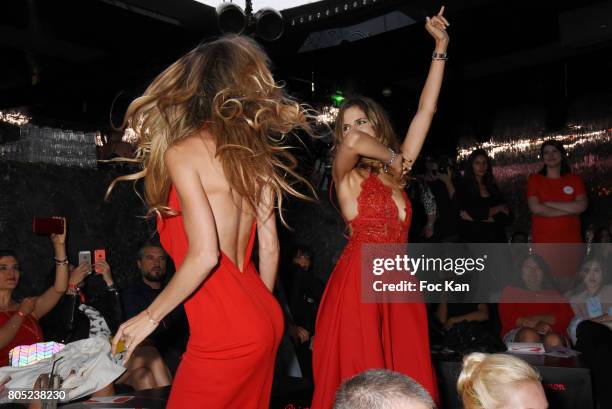 Presenters Candice De Saint Pern by Pierre Cardin and Margaux De Frouville by Laura Laval walk the runway during the 'Red Defile' Auction Fashion...