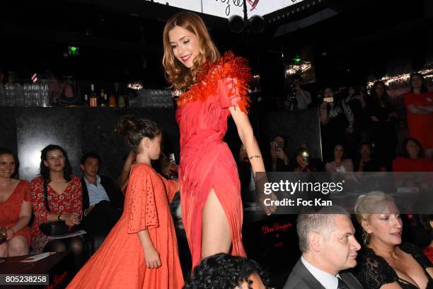 Veronique Mounier by On Aura Tout Vu and her daughter walk the runway during the 'Red Defile' Auction Fashion Show Hosted by Ajila Association...