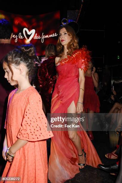 Veronique Mounier by On Aura Tout Vu and her daughter walk the runway during the 'Red Defile' Auction Fashion Show Hosted by Ajila Association...