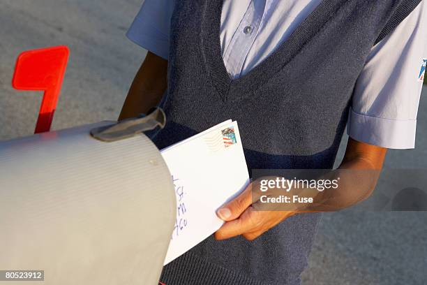 letter carrier delivering mail - domestic mailbox stock-fotos und bilder
