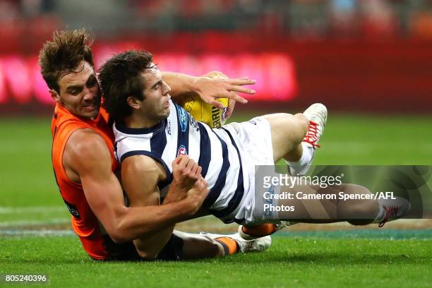 James Parsons of the Cats is tackled by Jeremy Finlayson of the Giants during the round 15 AFL match between the Greater Western Sydney Giants and...