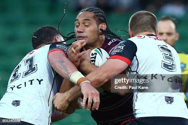 Martin Taupau of the Sea Eagles attempts to break thru a tackle by Bodene Thompson and Blake Ayshford of the Warriors during the round 17 NRL match...