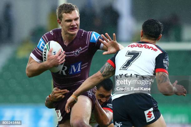 Tom Trbojevic of the Sea Eagles fends off atackle by Shaun Johnson of the Warriors during the round 17 NRL match between the Manly Sea Eagles and the...