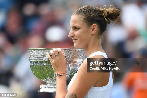 Champion Karolina Pliskova of the Czech Republic lifts the trophy following victory during the ladies singles final against Caroline Wozniacki of...