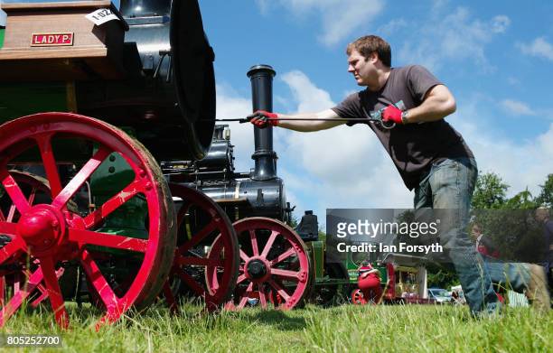 Man cleans the tubes of his steam engine during the Duncombe Park Steam Rally on July 1, 2017 in Helmsley, United Kingdom. Held annually in the...